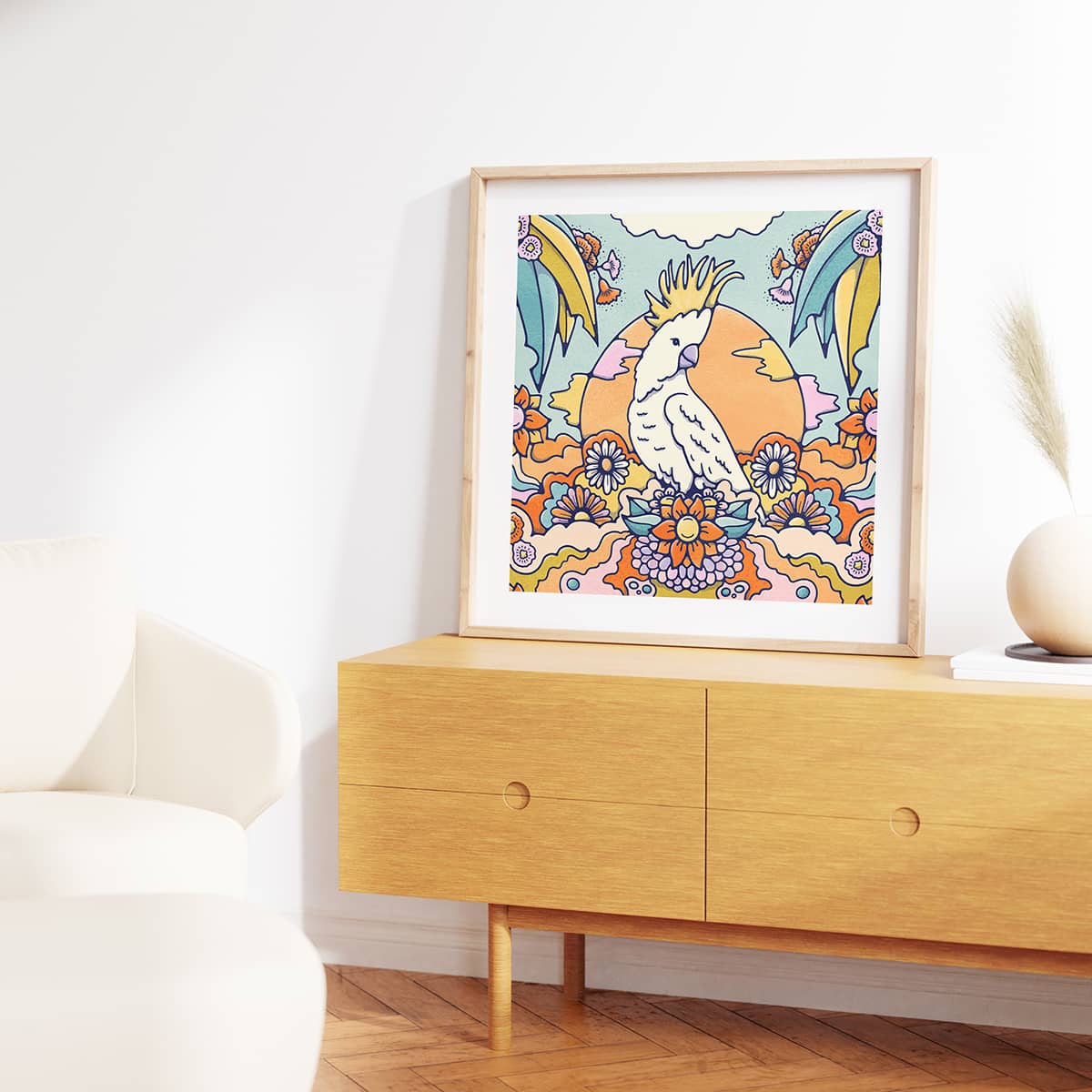 Cheeky cocktoo art print sitting in a landscape of vibrant flowers and eucalyptus trees